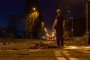 A police officer stands near the body of a victim at the site of a Russian ballistic missile strike in Kyiv. (Source: Mykyta Shandyba/UNITED24 Media)