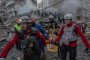 Rescuers evacuate an injured resident from a damaged apartment building following a Russian drone and missile strike on Kyiv on May 14, 2026. (Source: Getty Images)
