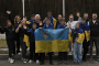 Ukrainian children and accompanying adults pose with Ukrainian flags. Illustrative image. (Source: Ombudsman of Ukraine)