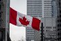 A Canadian flag is lowered to half-staff at the Guy-Favreau Complex. (Source: Getty Images)