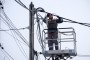 A power engineer of DTEK works on an aerial platform to repair power grids. (Source: Getty Images)