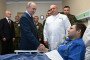 Russia’s leader Vladimir Putin (C) visits servicemen who were wounded during the Russian invasion of Ukraine, at a military hospital in Moscow on October 29, 2025. (Source: Getty Images)