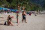 Visitors sit and walk along Patong Beach in Phuket, Thailand. (Source: Getty Images)
