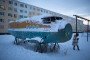 The broken fuselage of an old Antonov-2 aircraft stands in snow near a playground at the mining town of Udachny, Sakha Republic, Russia, on December 16, 2013. (Source: Getty Images)