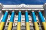 The Verkhovna Rada of Ukraine building is seen featuring sandbags placed behind windows and with the facade decorated in the colours of the Ukrainian flag. (Source: Getty Images)