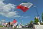 A man carries a Polish National Flag after a military parade in Katowice, on August 15, 2019, on Armed Forces Day. (Source: Getty Images)