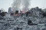A firefighter searches through heavy structural debris inside a damaged apartment building to locate trapped residents. (Source: Lucile Brizard/UNITED24 Media)
