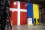 The Danish and the Ukrainian national flags are seen in the background as Denmark's Minister for Industry in Vojens, Southern Jutland, on December 1, 2025. (Source: Getty Images)