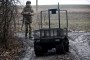 Ukrainian National Guard soldier of the 5th Skif Slobozhanska Brigade operates a domestically produced ground robotic system using a remote control unit, December 11, 2025. (Source: Getty Images)