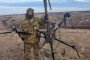 Russian soldier standing with a downed Ukrainian Vampire heavy bomber drone.