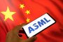The ASML logo appears on a smartphone screen, and the Chinese flag displays as the background on a laptop computer screen in this photo illustration. (Source: Getty Images)