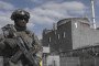An armed Russian serviceman stands outside reactor unit 1 at the occupied Zaporizhzhia Nuclear Power Plant. (Source: UNITED24 Media/YouTube)