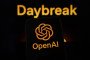 The OpenAI logo is displayed on a smartphone screen, with the Daybreak visual in the background, in Creteil, France, on May 12, 2026.