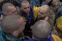 Released Ukrainian prisoners of war (POWs) embrace each other following a prisoner exchange at an undisclosed location, in the Chernihiv region on May 15. (Source: Getty Images)