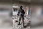 A man identified by AFP as a Bangladeshi recruit stands in military gear inside a damaged building after reportedly being recruited into the Russian army. Illustrative photo. (Source: AFP)