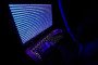 A person dressed as an internet hacker is seen with binary code displayed on a laptop screen, illustrative image. (Source: Getty Images)