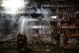 Ukrainian firefighters extinguish a blaze at the site of a Russian missile strike at an apartment building in Kyiv on October 14, 2026. (Source: Getty Images)