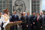 A Cuban honor guard marches as Russia’s leader stands with officials during a ceremony at Havana’s Revolution Square, with the iconic Che Guevara mural visible in the background