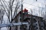 Utility workers on platform of cherry-picker truck conduct repair work of communication line at residential district after a Russian combined strike. (Source: Getty Images)
