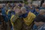 Released Ukrainian prisoners of war embrace each other following a prisoner exchange at an undisclosed location, in the Chernihiv region on May 15, 2026. (Source: Getty Images)