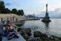 People sit on an embankment with the Monument of The Sunken Ships in the background in central Sevastopol. (Source: Getty Images)
