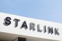 The Starlink corporate logo, part of the SpaceX ecosystem, is seen against a clear blue sky at the Fira Gran Via in Barcelona, Spain, on March 5, 2026. (Source: Getty Images)