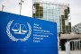 This photograph shows the International Criminal Court (ICC) in the background with its logo on a sign in the foreground in The Hague, on February 23, 2026. (Source: Getty Images)