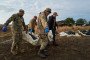 Platsdarm volunteers carry a body bag with the remains of a Russian soldier for identification on August 23, 2025 in Donetsk Region, Ukraine. Illustrative photo. (Source: Getty Images)
