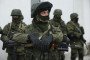 Soldiers who were among several hundred that took up positions around a Ukrainian military base stand near the base's periphery in Crimea on March 2, 2014, in Perevalne, Ukraine. (Source: Getty Images)