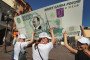Members of a social network group carry a one-thousand ruble banknote with Putin’s face in Moscow on August 18, 2011.
