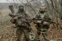 Two foreign mercenaries recruited by Russia pose with assault rifles before being sent to the front. (Photo: HUR)