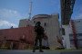 A Russian serviceman stands guard over the territory outside the second reactor of the Zaporizhzhia Nuclear Power Station in Energodar on May 1, 2022.