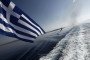 The flag of Greece flutters over the sea. (Source: Getty Images)