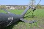 The wreckage of a downed Russian helicopter lies in a field near Kharkiv on April 16, 2022