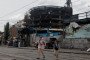 Children are running across the street by a damaged shopping center following Russian strikes in Kyiv on May 25, 2026. (Source: Getty Images)