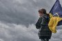 A child with a Ukrainian flag stands on the road. (Source: Getty Images)