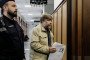 Police officers escort Alexander Butyagin, a Russian archaeologist suspected by Ukraine of unauthorised excavation and plundering of historical artefacts in Crimea, at the District Court in Warsaw, Poland. (Source: Getty Images)