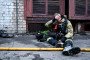 A firefighter wipes his forehead while sitting on the ground during a response effort to a Russian drone attack on June 14, 2025. Illustrative photo.