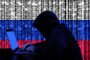 A hacker in a dark hoodie works on a laptop against a digital background featuring the Russian flag and binary code. Illustrative photo. (Source: Getty Images)