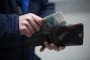 A customer handles 1000 ruble banknotes from a wallet. (Source: Getty Images)