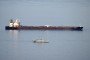 Military ships patrol the Smyrtos vessel outside the harbour, on June 14, 2026, in Portland, England.
