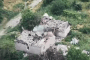 Drone footage shows a heavily damaged building with smoke rising from the structure. (Source: Ukrainian Special Operations Forces)