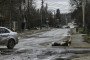 A man walks on a street with several dead bodies on the ground in Bucha, northwest of Kyiv, as Ukraine says Russian forces are retreating from northern areas around Kyiv and the city of Chernihiv, on April 2, 2022. (Source: Getty Images)