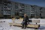 An elderly woman sits on a bench in Yakutsk on March 28, 2025. (Source: Getty Images)