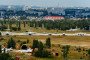 Arched concrete shelters for aircraft and, in the background, aircraft parking and a military training and research center at the Russian Baltimor military airfield in Voronezh.