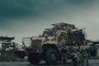 3rd Assault Corps soldiers stand in front of the International MaxxPro armored vehicle.