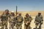 Alleged members of the Wagner Group pose for a photo in a desert landscape, equipped with a mix of Russian and Middle Eastern-style military uniforms. (Source: Russian media)