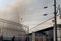Smoke rises behind an industrial facility, with railway cars in Novorossiysk, Russia. (Source: Ukrainian President Volodymyr Zelenskyy/X)