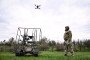 A soldier with the call sign ''Pavuk'' (''Spider'') watches a drone take off from a ground robotic complex during trials at a training ground on April 10, 2026. (Source: Getty Images)