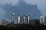 A plume of smoke from a fire in a Kyiv suburb rises behind the Motherland Monument and apartment blocks in the Pechersk district, Kyiv, Ukraine, on August 28, 2026.